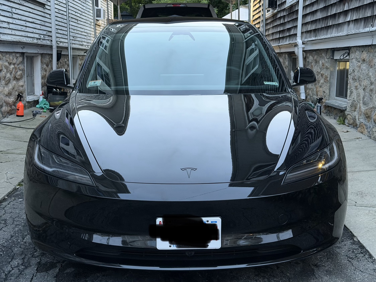 After detailing: the black vehicle's clean front end and glossy paint