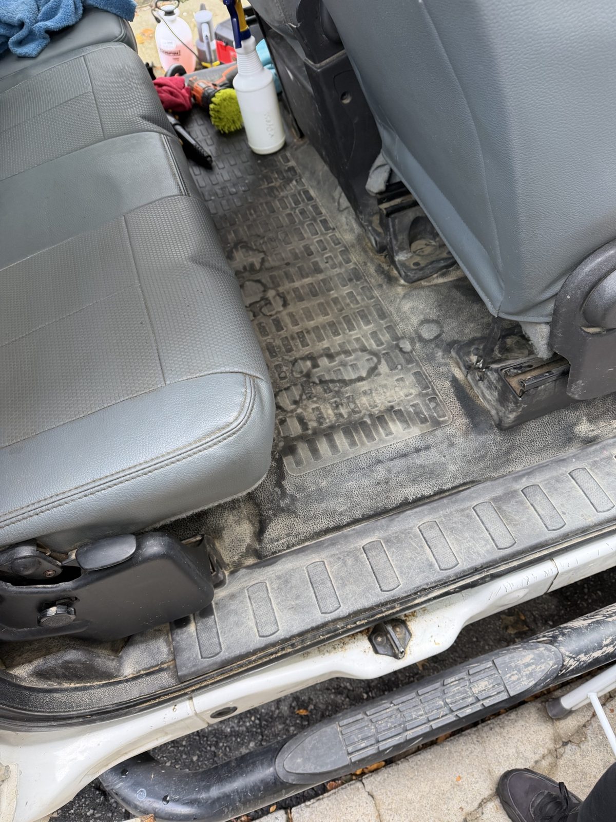 Before: dirt and staining across the rear floor and seat base