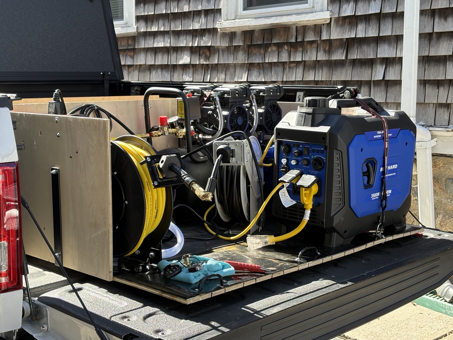 The Mobile Maxx truck setup with hose reels, compressor and generator ready for mobile service